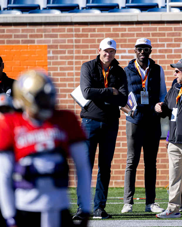 Kevin O'Connell and Kwesi Adofo-Mensah watch quarterback Michael Penix Jr. at the Senior Bowl in Mobile, Alabama.